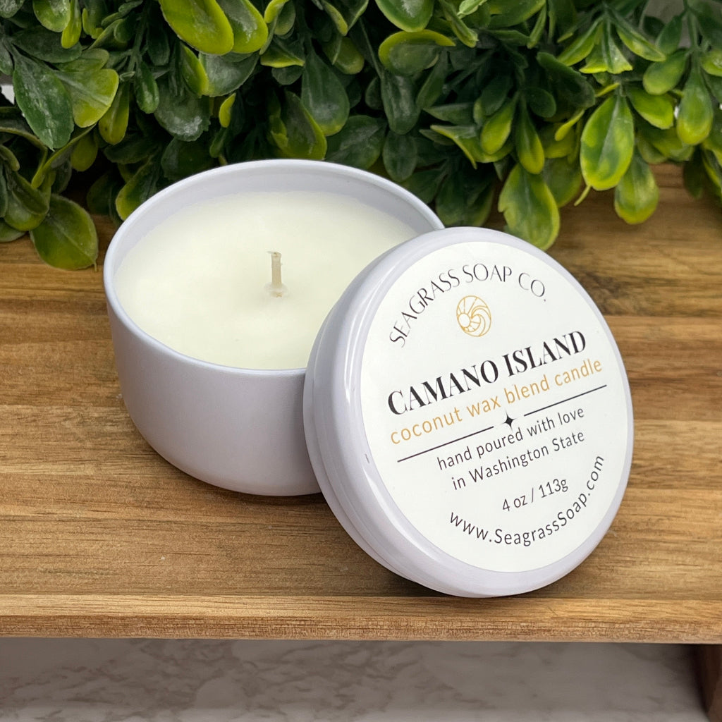 Camano Island Travel Candle in a 4 oz reusable tin scented in fresh sea salt, sparkling ozone, hint of floral and musk and infused woods. Great souvenir or gift!