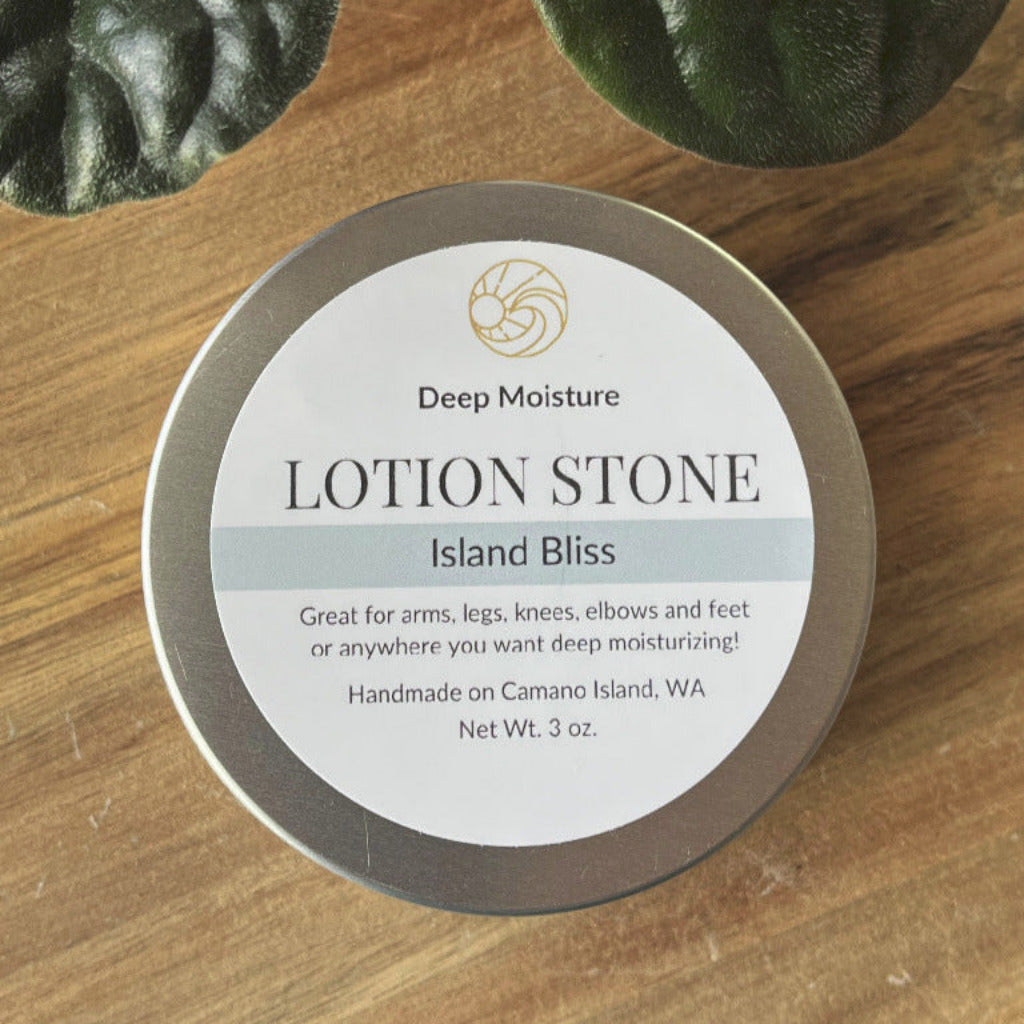 Lotion bar container and label next to a green plant