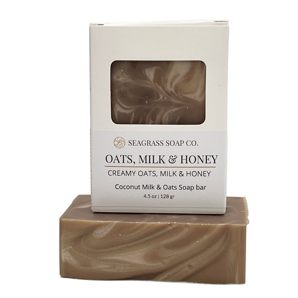 Oatmeal, milk and honey bar of soap with packaging labeled 'Seagrass Soap Co.' on a white background
