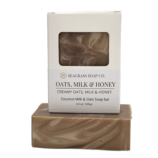 Oatmeal, milk and honey bar of soap with packaging labeled 'Seagrass Soap Co.' on a white background