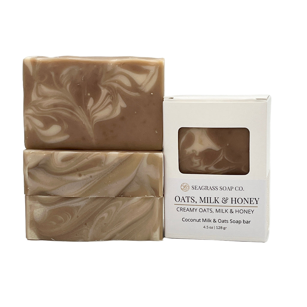 Multiple soap bars with cream swirl design and a Seagrass Soap Co. packaging box on a white background