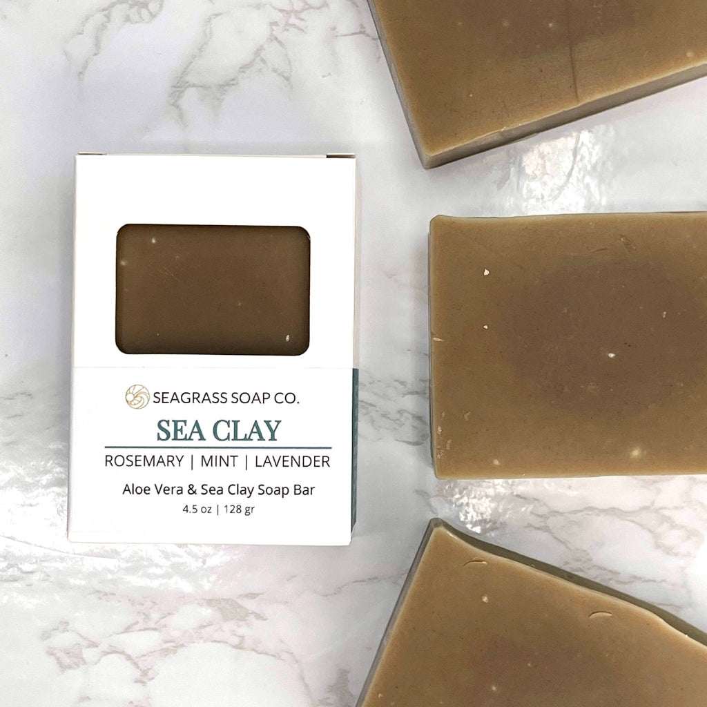 Three Sea Clay Soap Bars and its box packaging on a marbled surface
