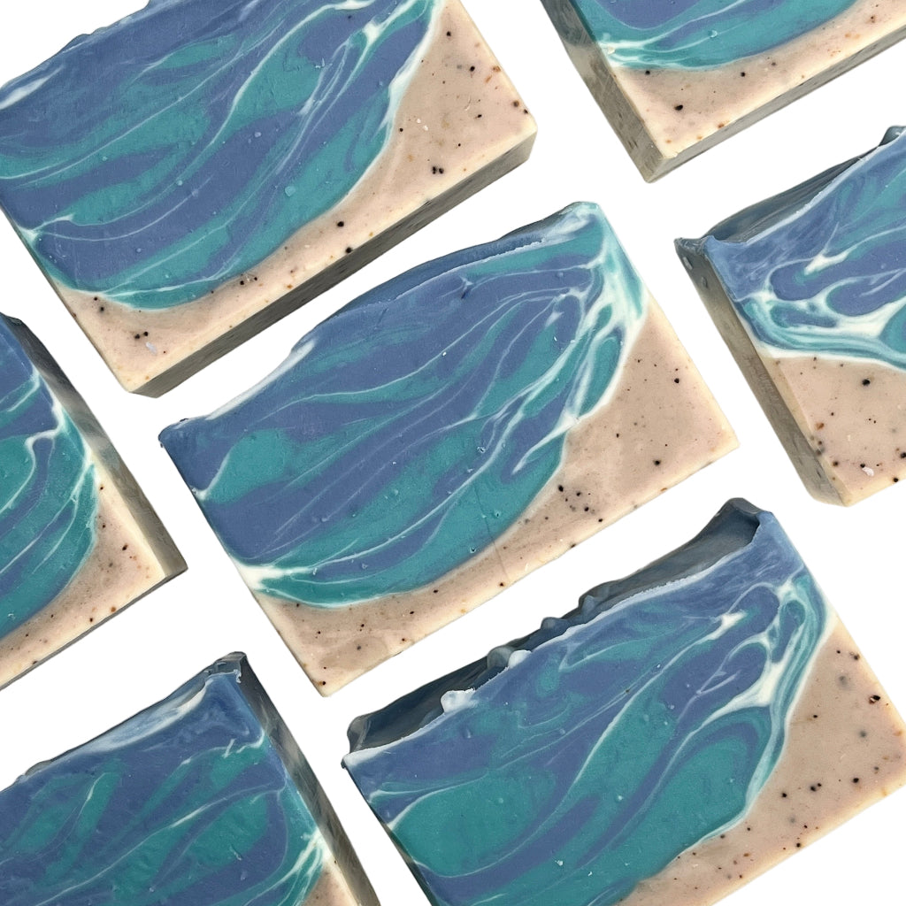 Square soap bars with blue and green ocean design on a white background