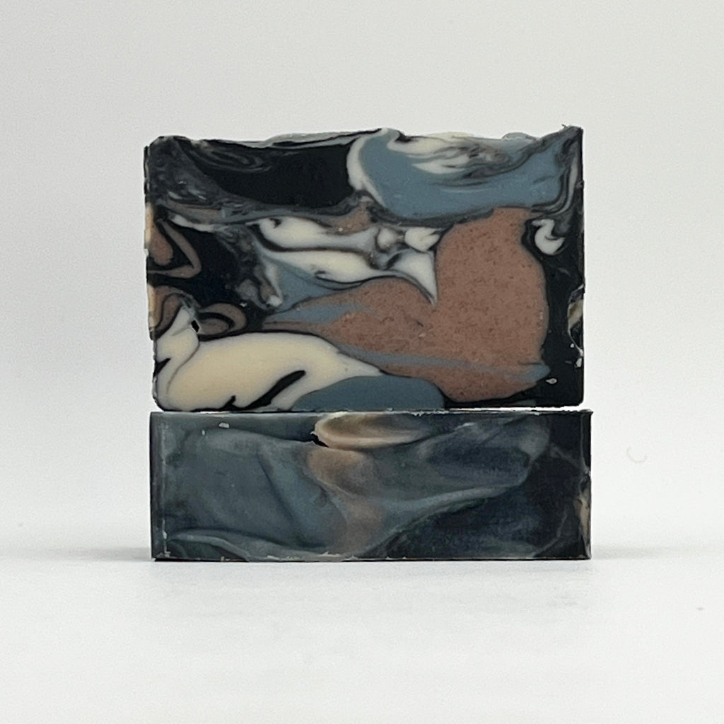 Beachwood ocean water marbled soap bar with black, gray, and brown colors on a white background by Seagrass Soap Co