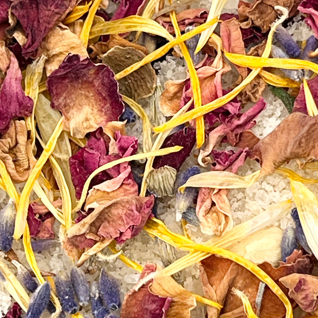 Close-up of dried flowers and bath salts in a glass jar