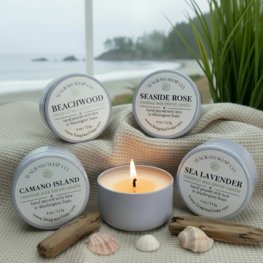 Set of Seagrass Soap Co. candles with labels on a textured surface with a natural background.