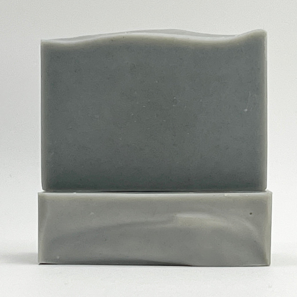 Coastal Mist natural, ocean water soap bar with Eucalyptus and Mint essential oils in a grey color on a white background.