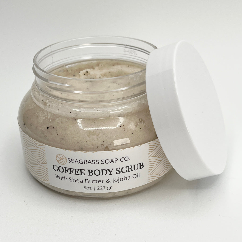 Open jar of coffee body scrub with Seagrass Soap Co. branding on a white background
