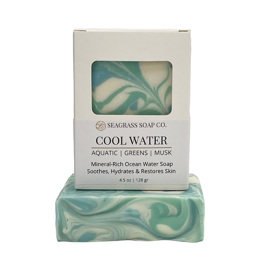 Cool Water Bar of soap with swirled design and packaging labeled 'Seagrass Soap Co.  on a white background.