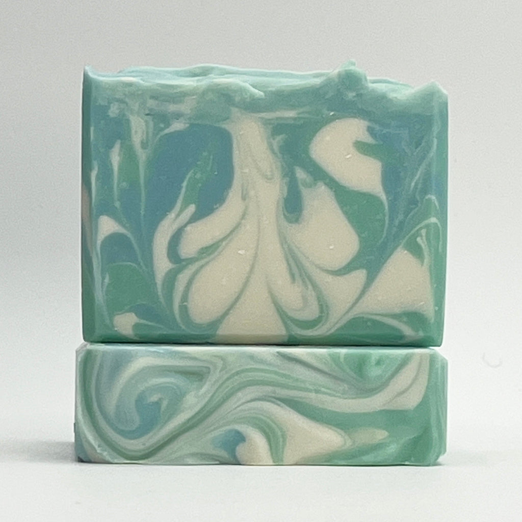 Cool Waters ocean water soap bar with green, blue and white swirls on a white background by Seagrass Soap Co.