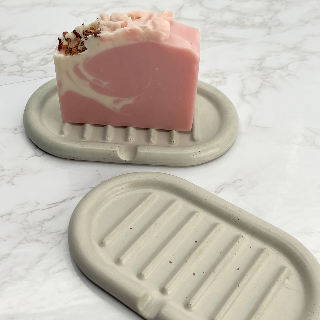 Hand poured, self draining concrete soap dish in cream color with Sea Rose Soap Bar.