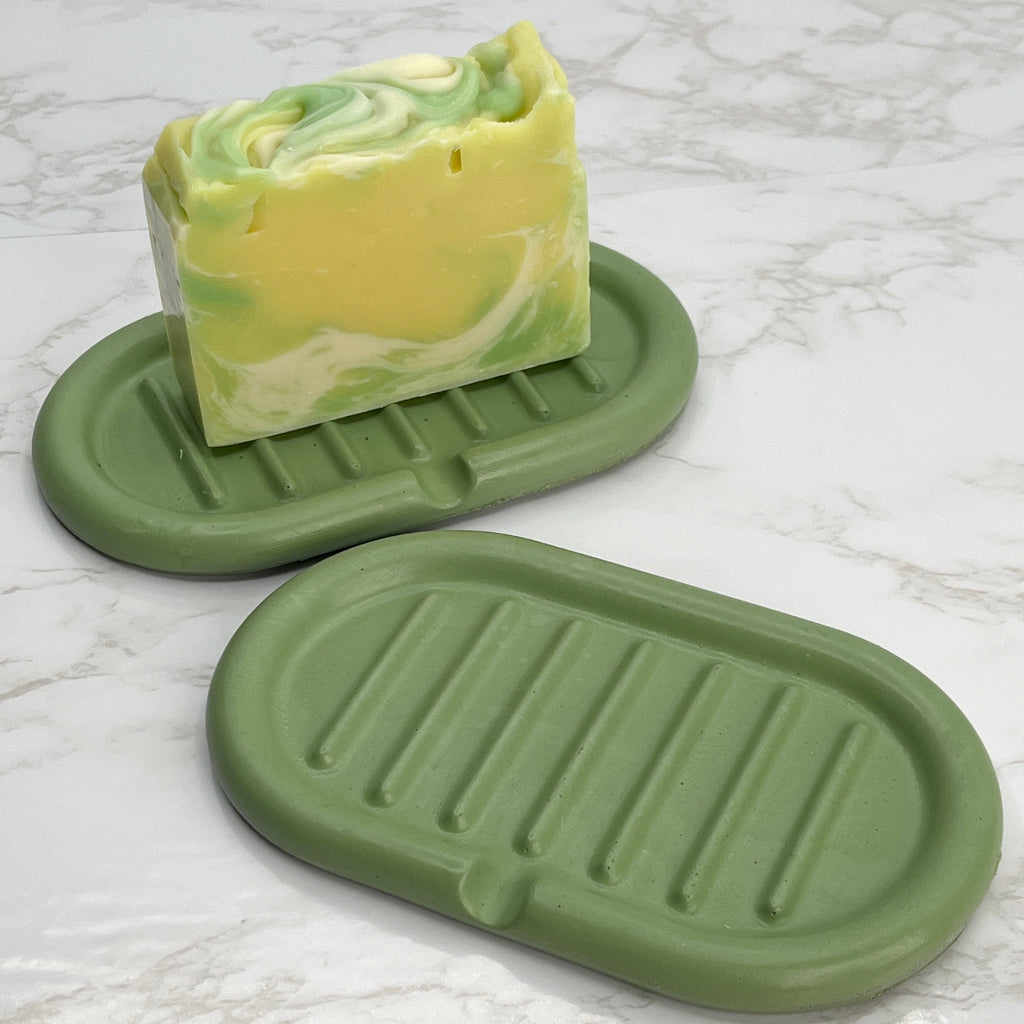Hand poured self draining concrete soap dish in green for kitchens or bathrooms.