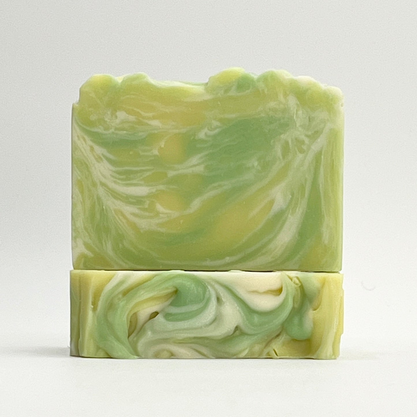 Harbor Fresh ocean water soap bar scented in Lemon Verbena, Amber and Musk with yellow, green and white swirls on a white background.