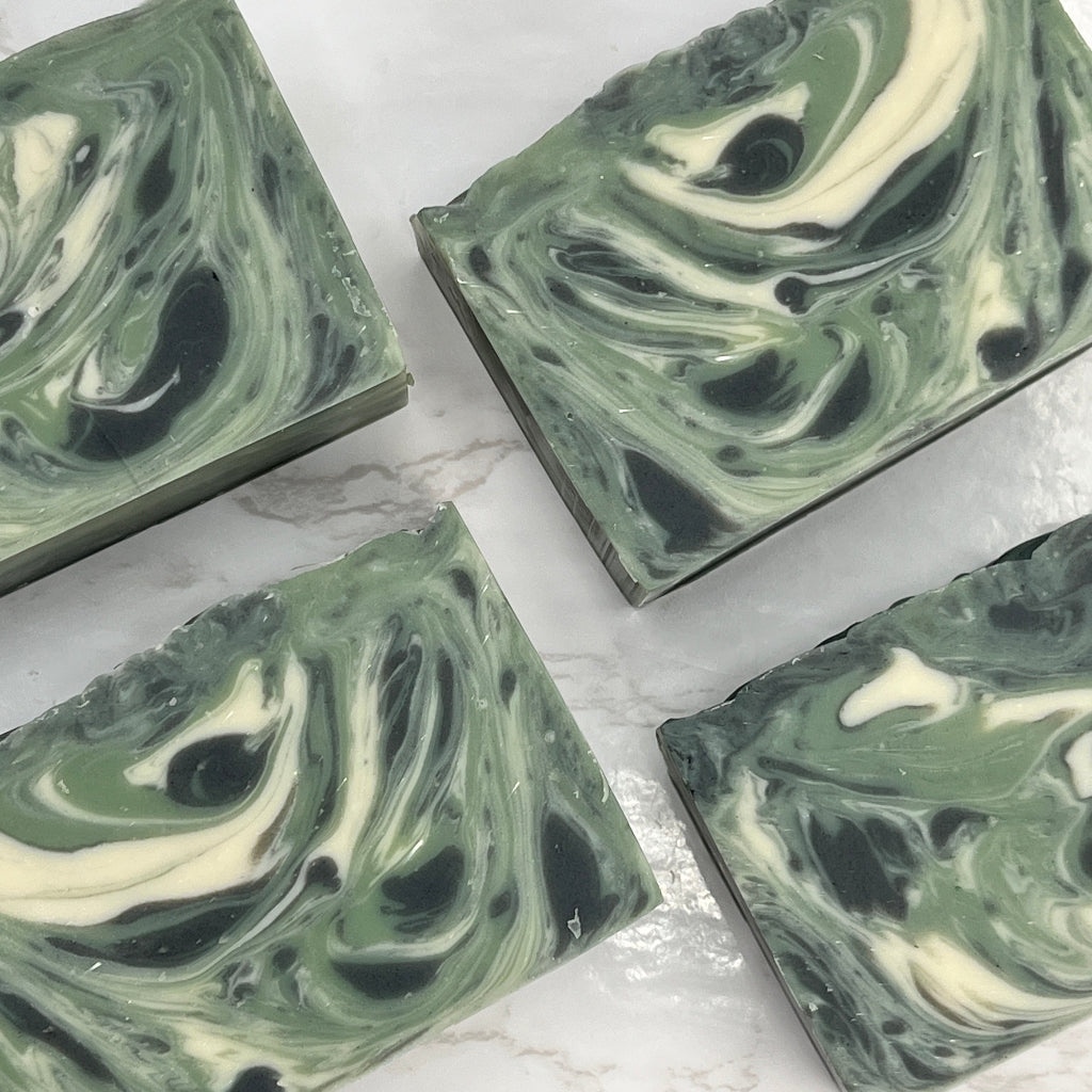 Forest has a woodsy scent and swirls of white and black in a green base.