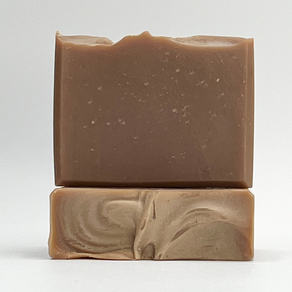 Oats, Milk, Honey soap bar enriched with soothing coconut milk in a light brown shade on a white background.
