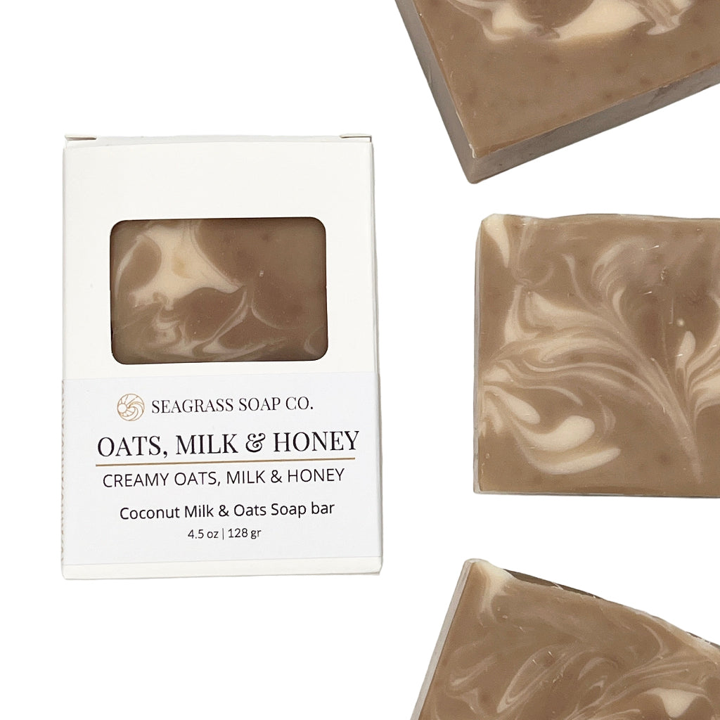 Three soap bars with a cream swirl pattern next to their packaging on a white background