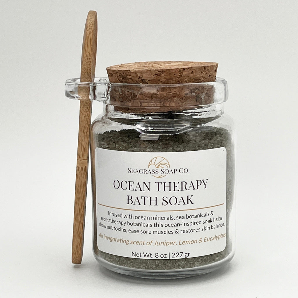 Ocean Therapy Bath Soak in a jar with a wooden spoon on a white background and a cork lid.