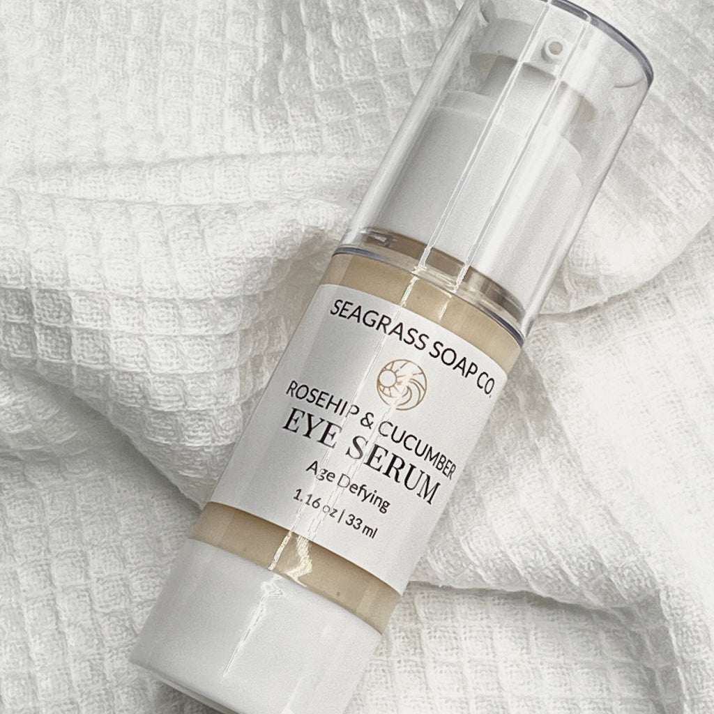 Eye serum bottle labeled 'Rosehip & Cucumber' by Seagrass Soap Co. on a textured white background.