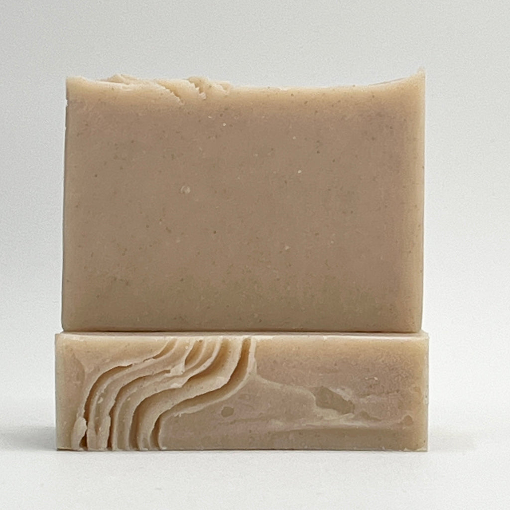 Sandy Shores soap bar scented with jasmine, sea breeze and mandarin. Enriched with pumice and volcanic sands for a gentle exfoliation in a natural color on a white background by Seagrass Soap Co.