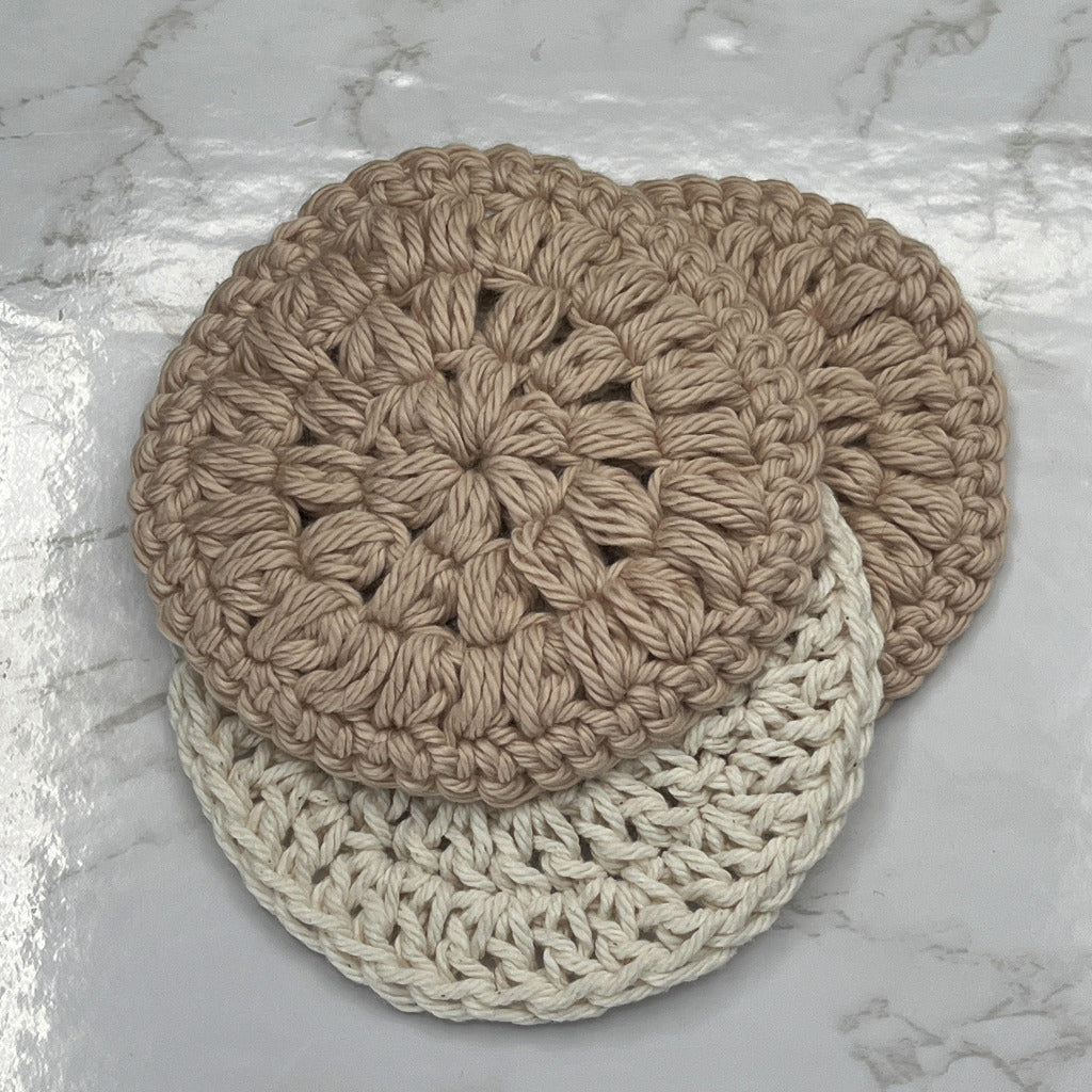 Set of three face cleansing round scrubbies. Two are a solid tan color and one is a cream color.
