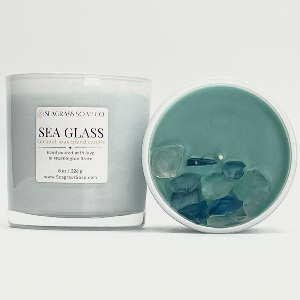 Sea Glass candle with visible sea glass pieces inside, branded by Seagrass Soap Co. on a white background