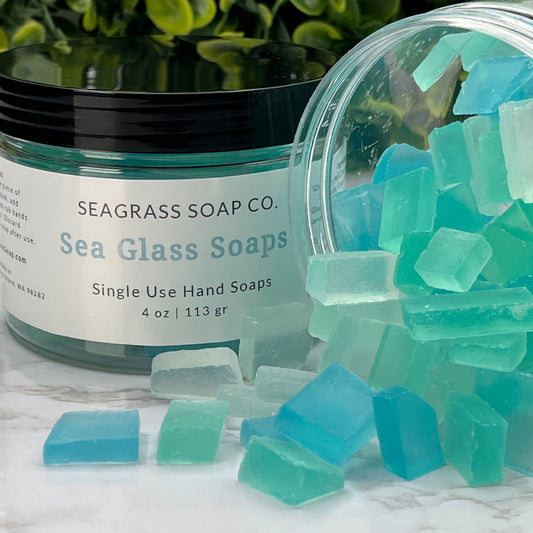 Single use mini soaps that resemble sea glass.