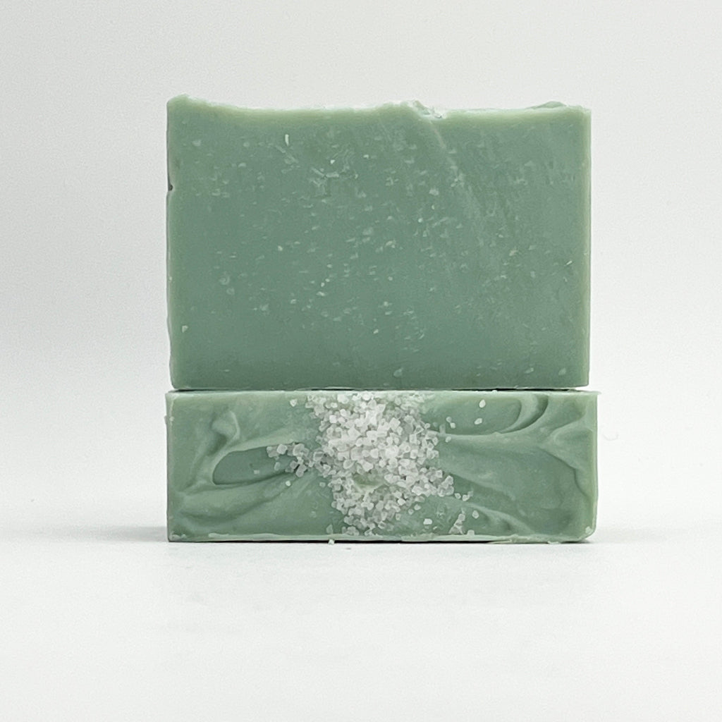 Two green Sea Glass ocean water soap bars on a white background
