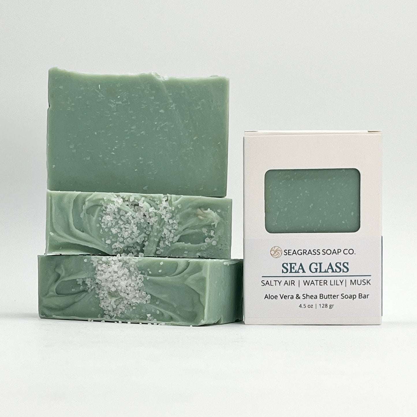 Green soap bars with a Seagrass Soap Co packaging on a white background