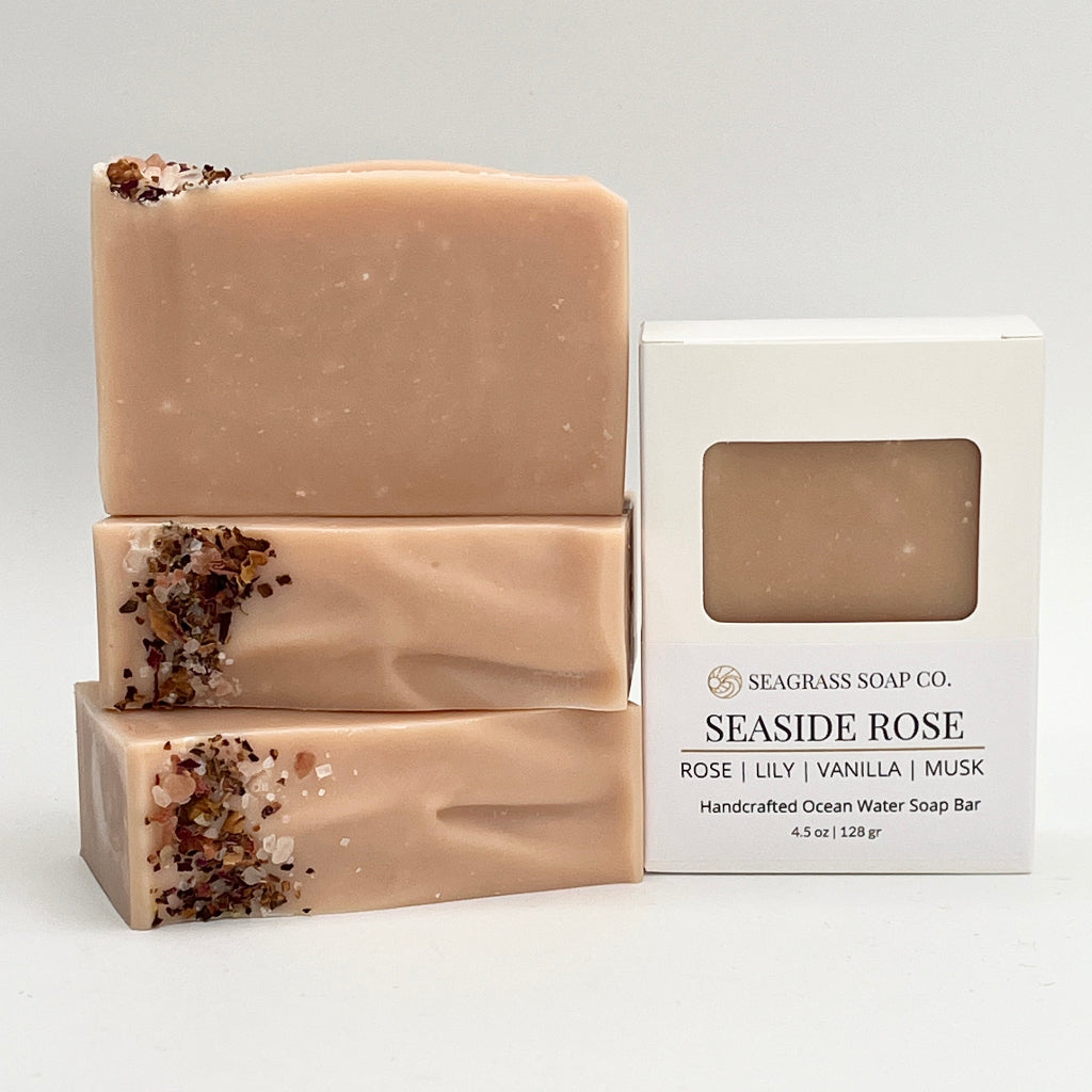 Three stacked Seaside Rose soap bars with a white box on a light gray background