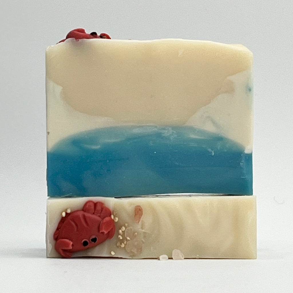 Tide Pool ocean water soap bar beach theme with cute crab soap sitting on top on a white background by Seagrass Soap Co.