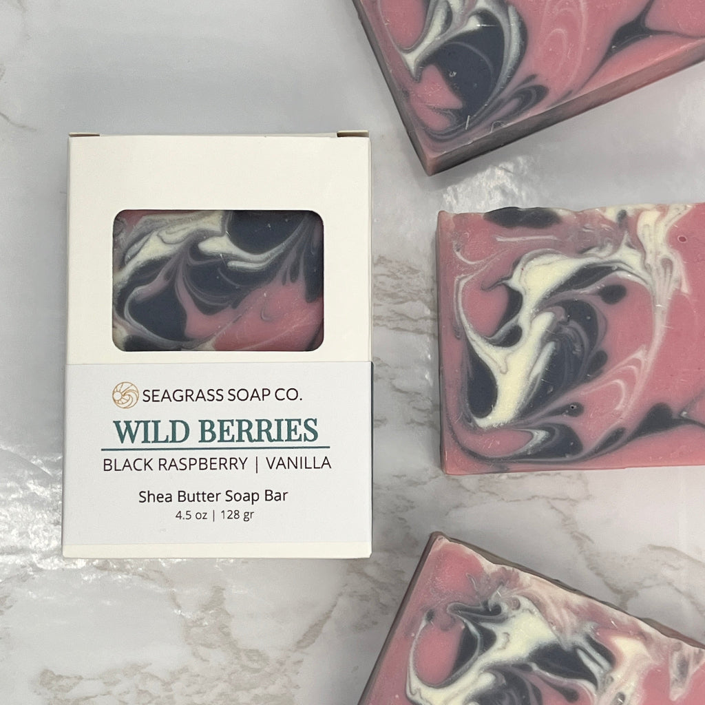 Wild Berries Soap Bars and box package enriched with Shea Butter and a berry scent on a marbled surface.