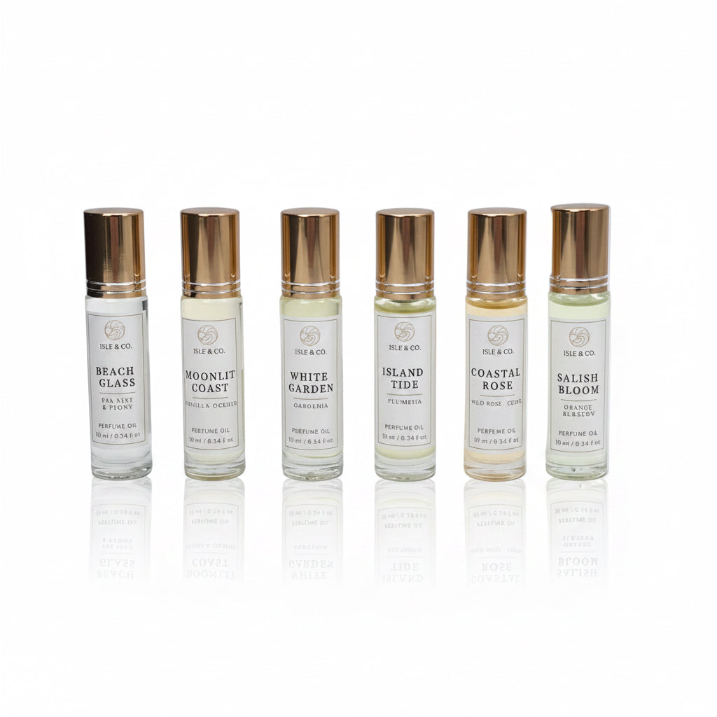 Six roll-on perfume bottles with gold caps on a white background
