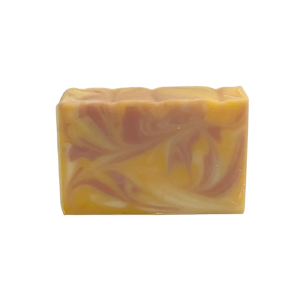 Close up of sweet orange hibiscus citrus herbal soap made with natural oils, hibiscus and annatto.
