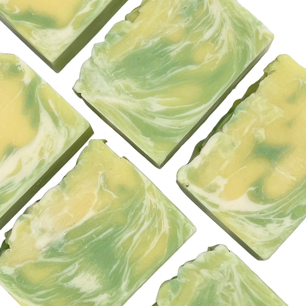 Green and yellow swirled soap bars on a white background