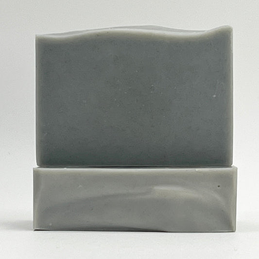 Coastal Mist natural, ocean water soap bar with Eucalyptus and Mint essential oils in a grey color on a white background.