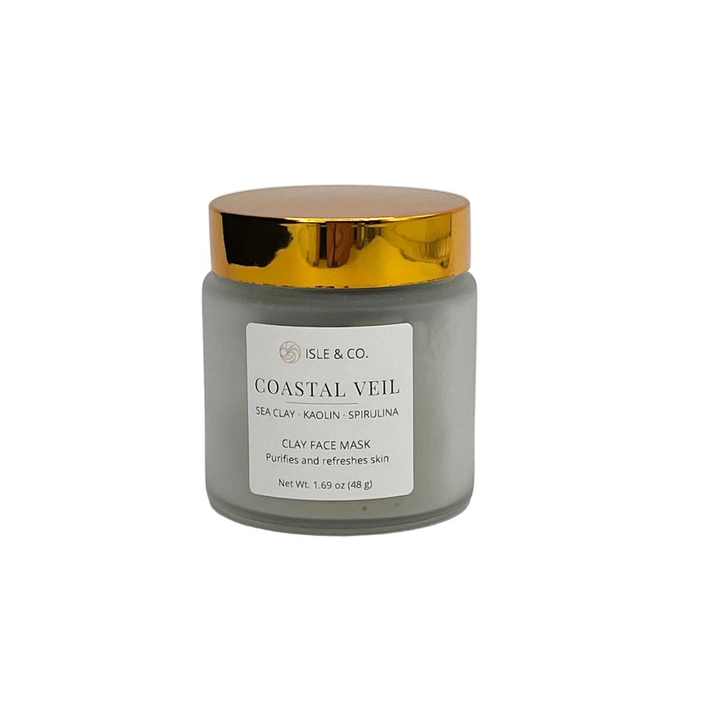 Jar of 'Coastal Veil' purifying face mask with a gold lid on a white background
