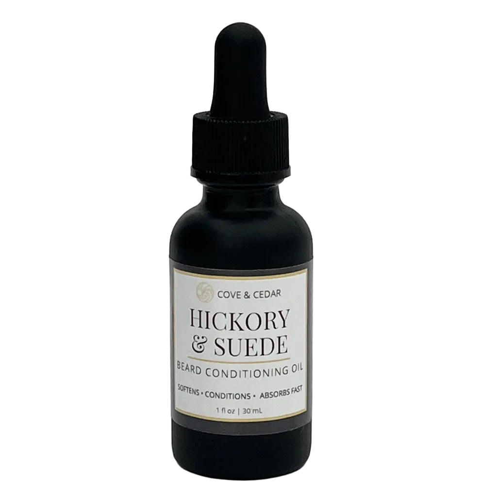 Black bottle of 'Hickory & Suede' beard conditioning oil with a dropper on a white background