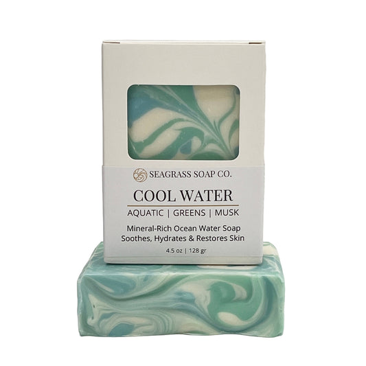Cool Water Bar of soap with swirled design and packaging labeled 'Seagrass Soap Co.  on a white background.