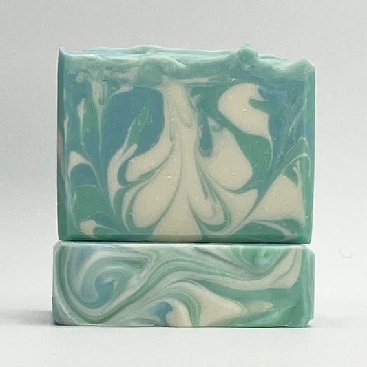 Cool Waters ocean water soap bar with green, blue and white swirls on a white background by Seagrass Soap Co.