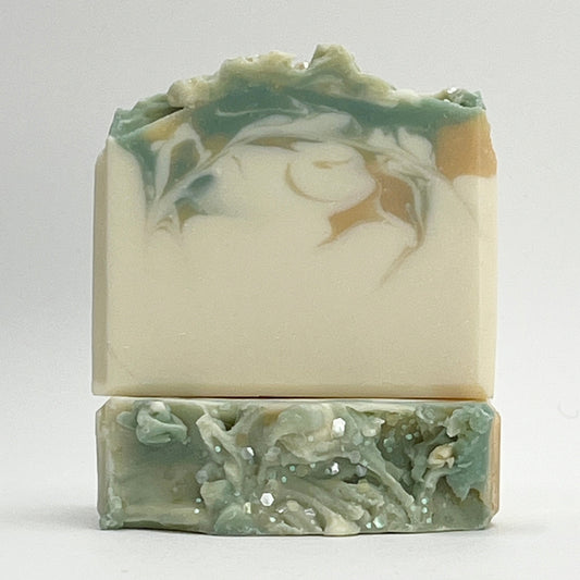 Glacier Meadows soap bar with green and gold swirls on a white base with a white background by Seagrass Soap Co