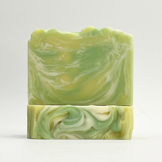 Harbor Fresh ocean water soap bar scented in Lemon Verbena, Amber and Musk with yellow, green and white swirls on a white background.