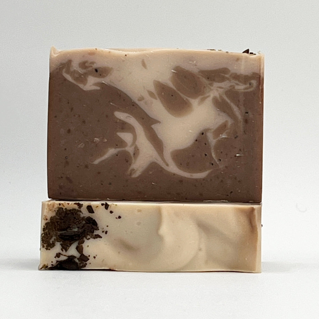 Island Coffee ocean water soap bar with exfoliating organic coffee beans showing brown and cream swirls on a white background by Seagrass Soap Co.