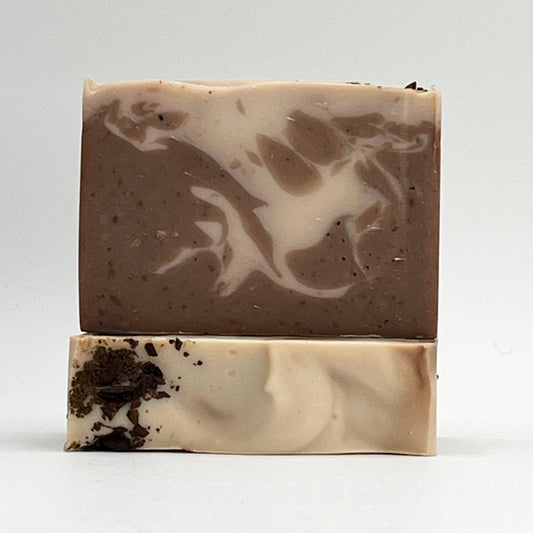 Island Coffee ocean water soap bar with exfoliating organic coffee beans showing brown and cream swirls on a white background by Seagrass Soap Co.