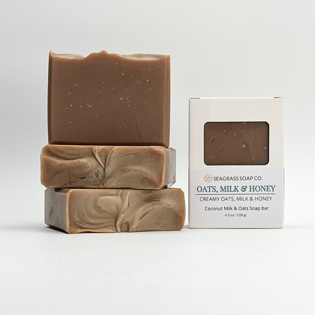 Oats, milk and honey scented coconut milk soap bar and packaging on a white background by Seagrass Soap Co.