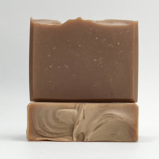 Oats, Milk, Honey soap bar enriched with soothing coconut milk in a light brown shade on a white background.