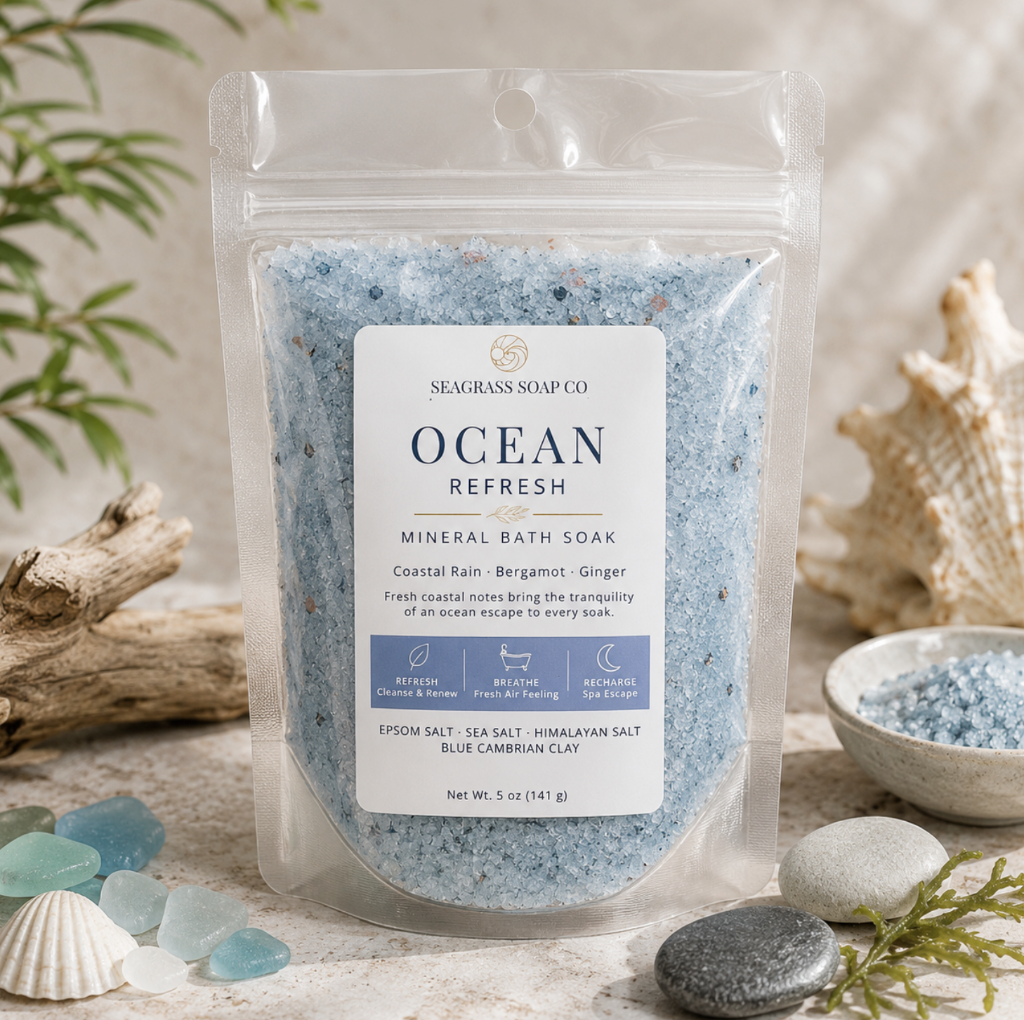 Ocean mineral bath soak package displayed with coastal-inspired accents on a neutral stone surface.