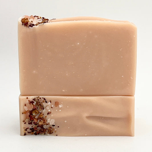 Seaside Rose soap bar with rose clay and rose petals on a white background.