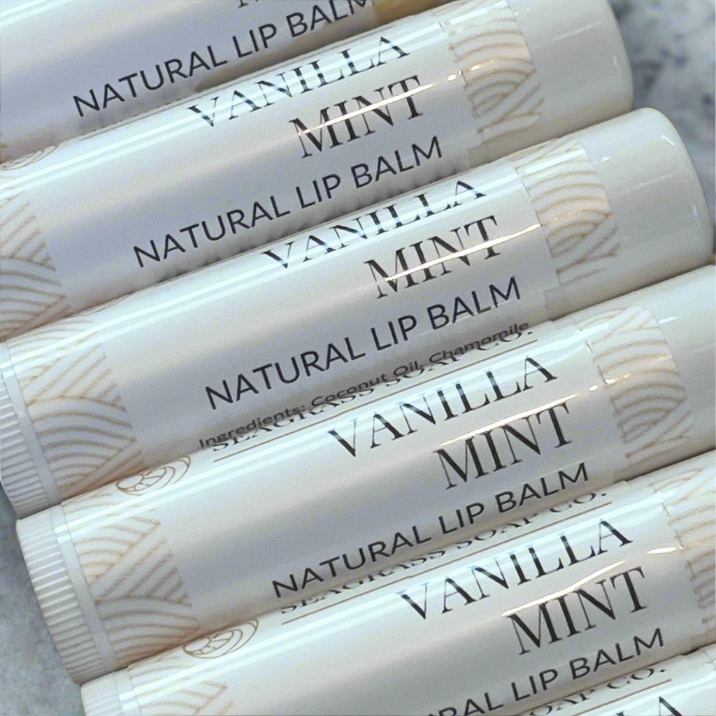 Several tubes of vanilla mint lip balm on a marbled surface.